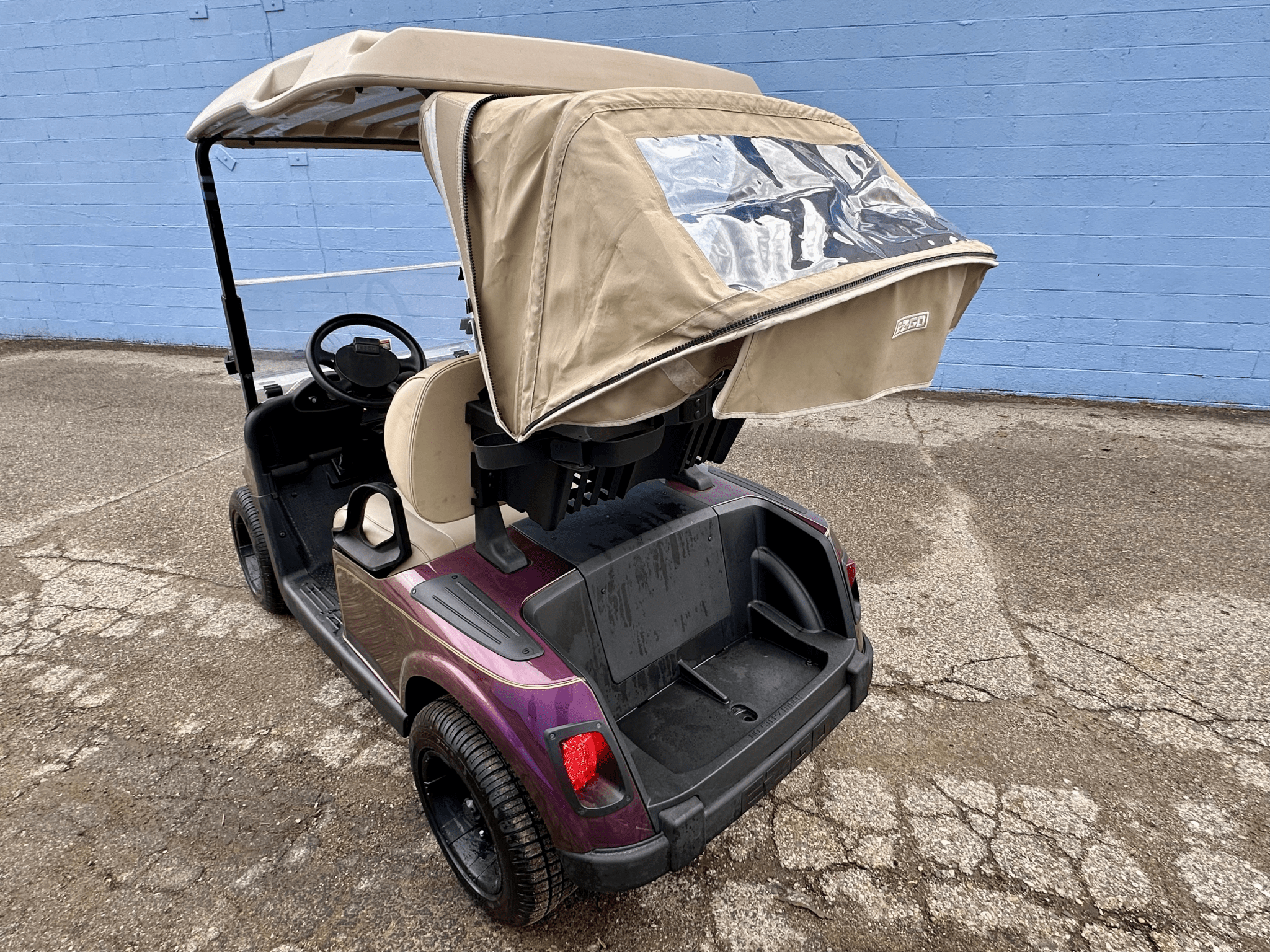 Burgundy EZGO Golf Cart with Rain Cover - Chief Cart Inc.