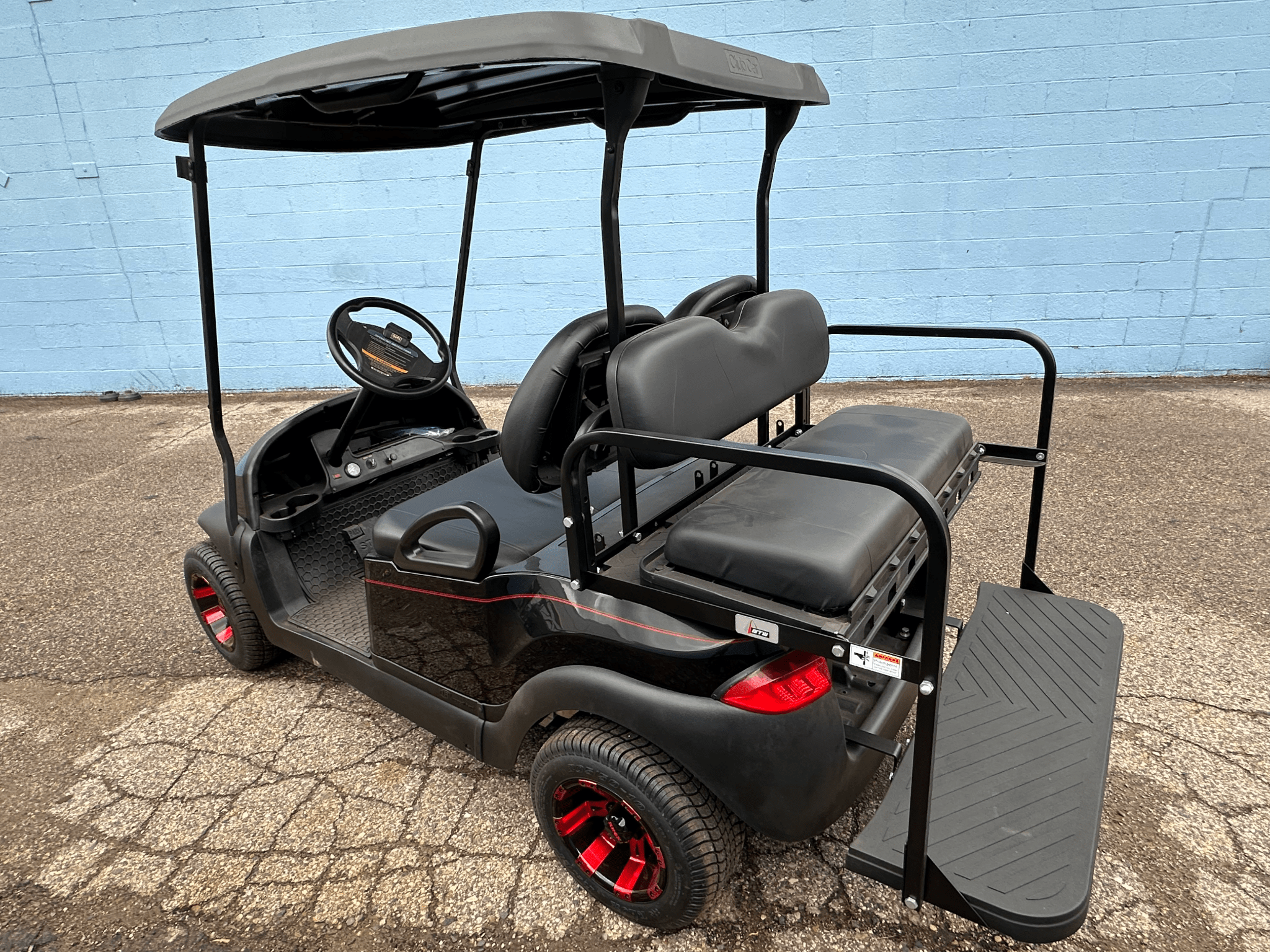 Custom Black E - Z - GO Golf Cart with Red Rims | Custom Electric Golf Cart - Chief Cart Inc.
